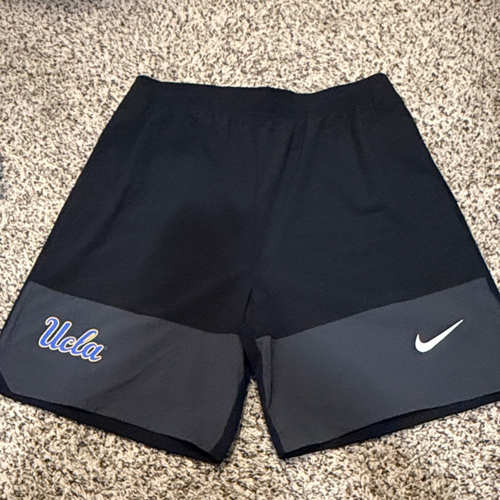 Nike Black Athletic Shorts with Gray Panels and Blue UCLA Script